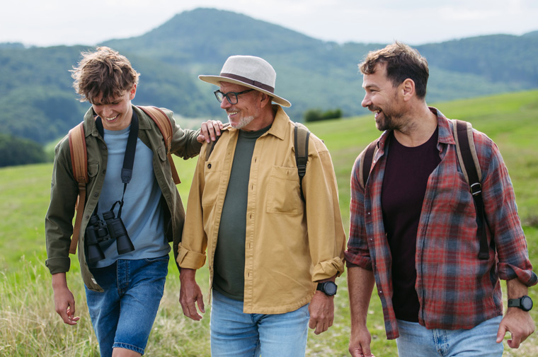 father, son, and grandfather on a nature hike