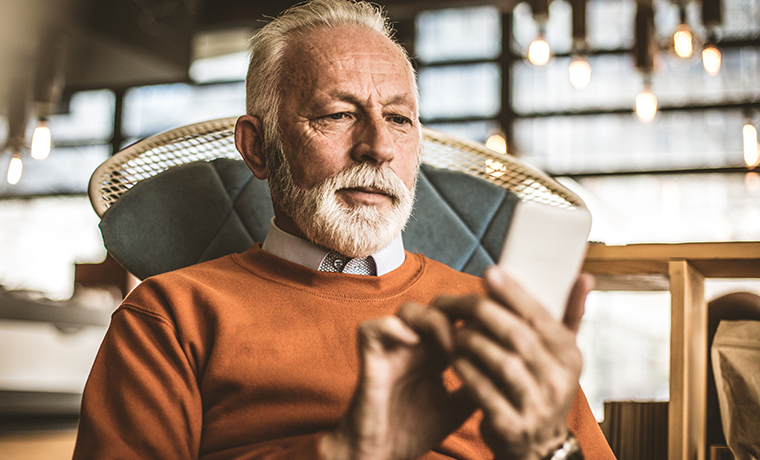 Older man looking at his phone