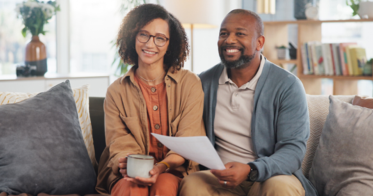 Couple sitting on their couch listening to an advisor