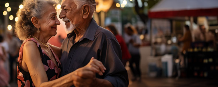 Senior couple dancing outside