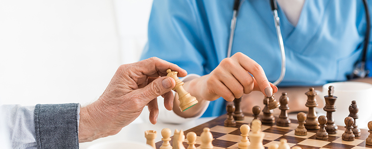 Two senior women playing chess
